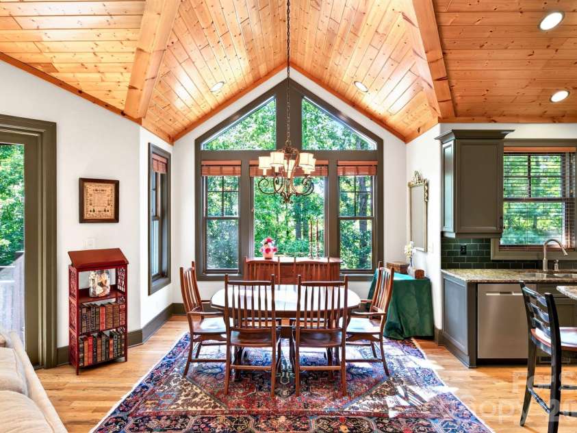33 Hawks Branch Circle, Fairview, NC 28730.  MLS# CAR4403173, YatesRealty ID 38919. Dining area framed by large windows overlooking the woods