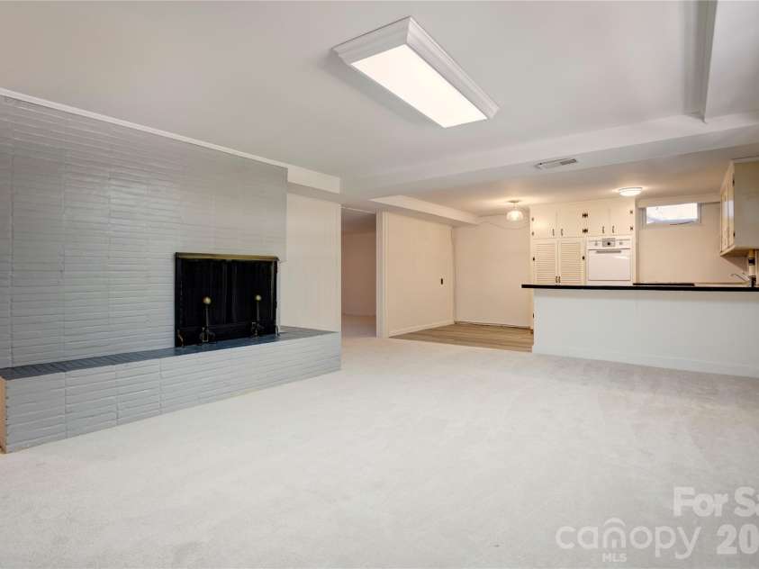 688 Grandview Drive, Concord, NC 28025.  MLS# CAR4433877, YatesRealty ID 38977. Family room/kitchen flow (basement)