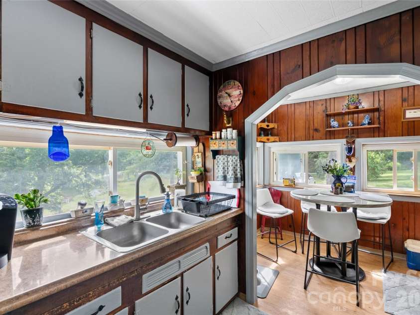 3151 Bearwallow Road, Hendersonville, NC 28792.  MLS# CAR4403717, YatesRealty ID 38983. Kitchen looking into eat-in area w/windows