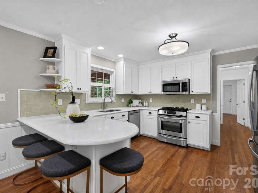 8127 Prince George Road, Charlotte, NC 28210.  MLS# CAR4396240, YatesRealty ID 38989. Kitchen island with bar seating