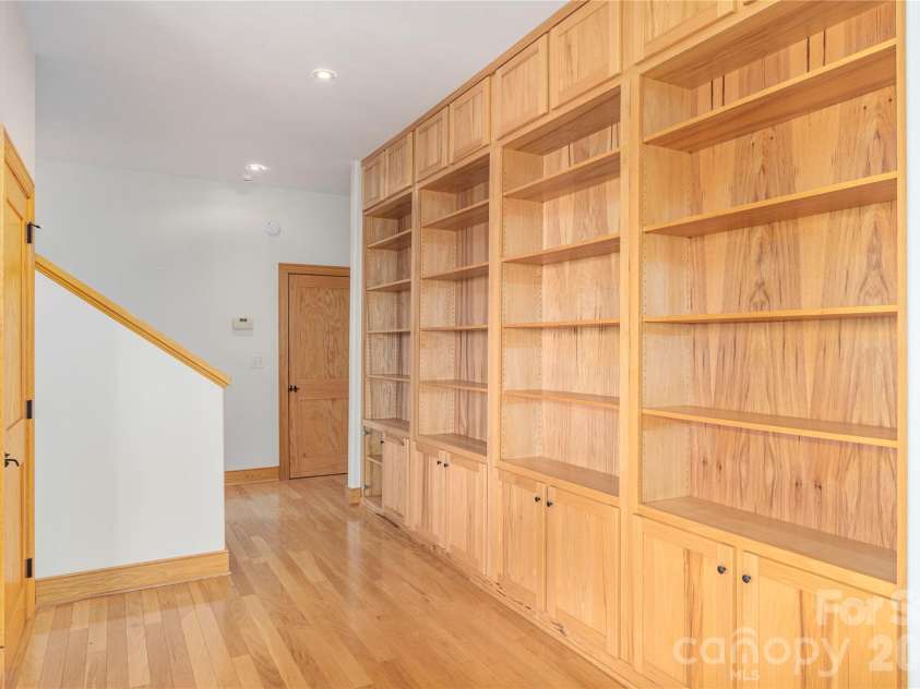 98 Flat Creek Road, Fairview, NC 28730.  MLS# CAR4395536, YatesRealty ID 38996. Lower level built-in book cases