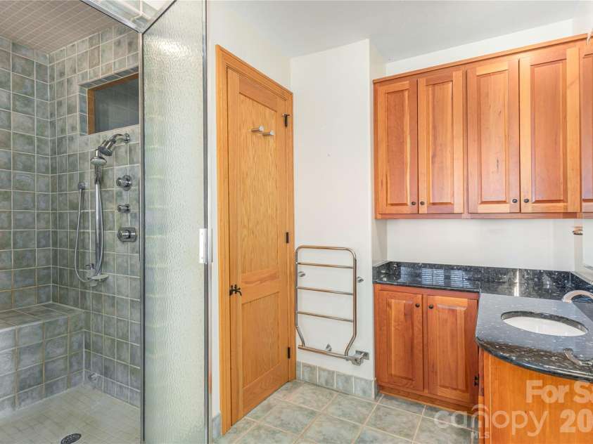 98 Flat Creek Road, Fairview, NC 28730.  MLS# CAR4395536, YatesRealty ID 38996. Primary bath with towel warmers and separate vanities