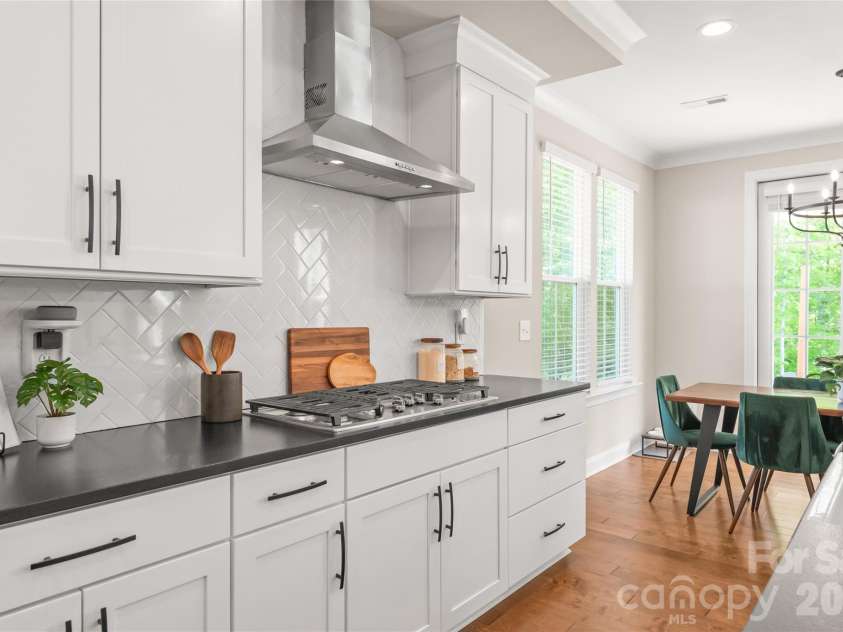3213 Timber Run Lane, Maiden, NC 28650.  MLS# CAR4371806, YatesRealty ID 39002. Elevate your cooking experience with the sleek GE wall-mounted range hood and a high-performance gas cooktop.