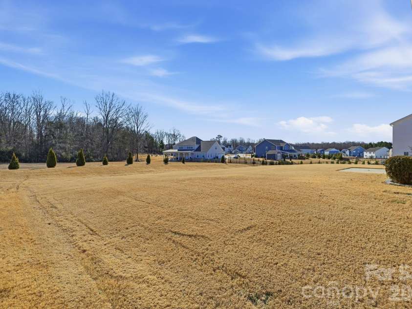1504 Brooksland Place, Waxhaw, NC 28173.  MLS# CAR4347761, YatesRealty ID 3901. Backyard facing the woods