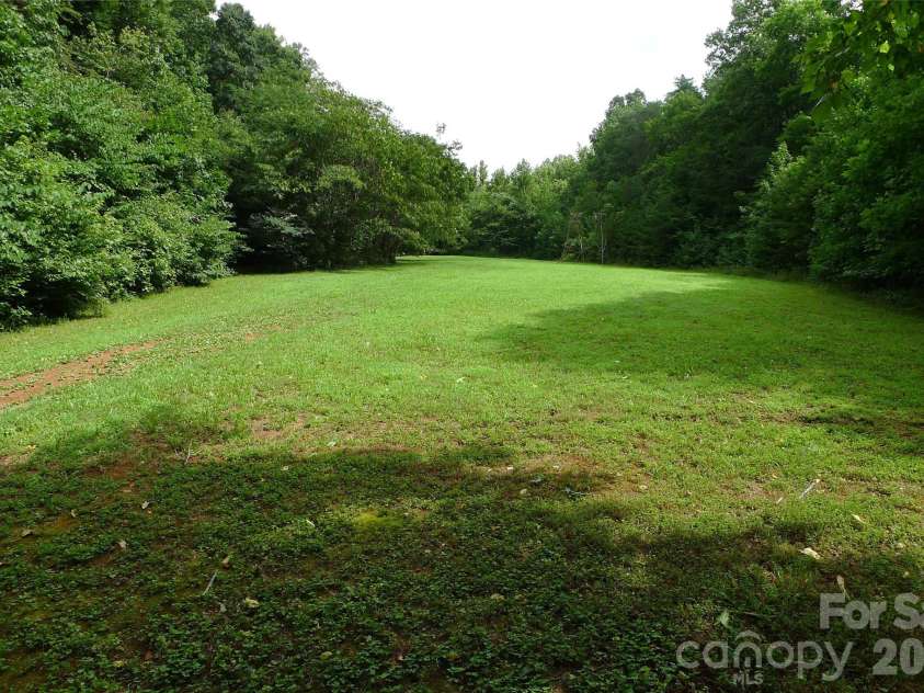 241 Grannaman Drive, Mocksville, NC 27028.  MLS# CAR4406242, YatesRealty ID 39017. Cleared grassy area