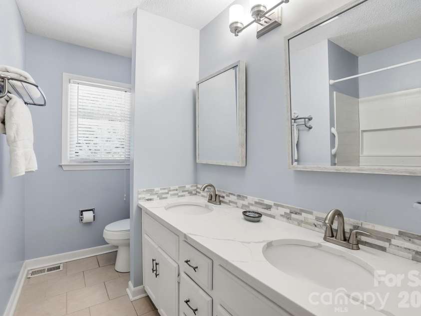701 Blue Rock Drive, Charlotte, NC 28213.  MLS# CAR4395254, YatesRealty ID 39020. The hall bath boasts dual vanities