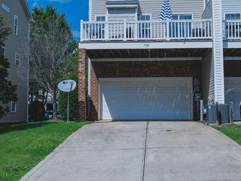 7051 Brighton Park Drive, Charlotte, NC 28227.  MLS# CAR4399270, YatesRealty ID 39034. A 2 car garage with additional parking