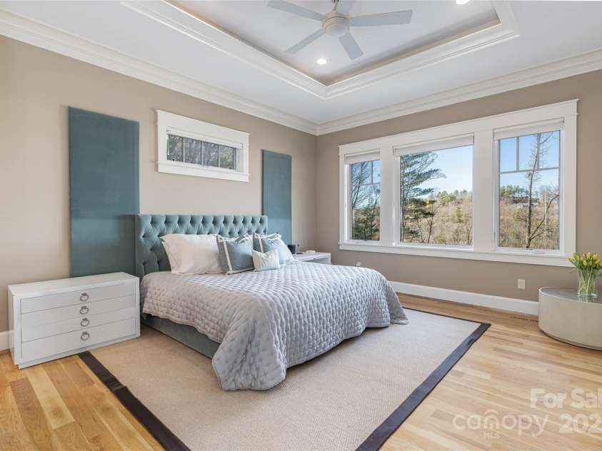 32 Timberwolf Court, Asheville, NC 28804.  MLS# CAR4141057, YatesRealty ID 3907. The primary suite has lovely tray ceilings with layered crown molding. Experience those long range views from bed.