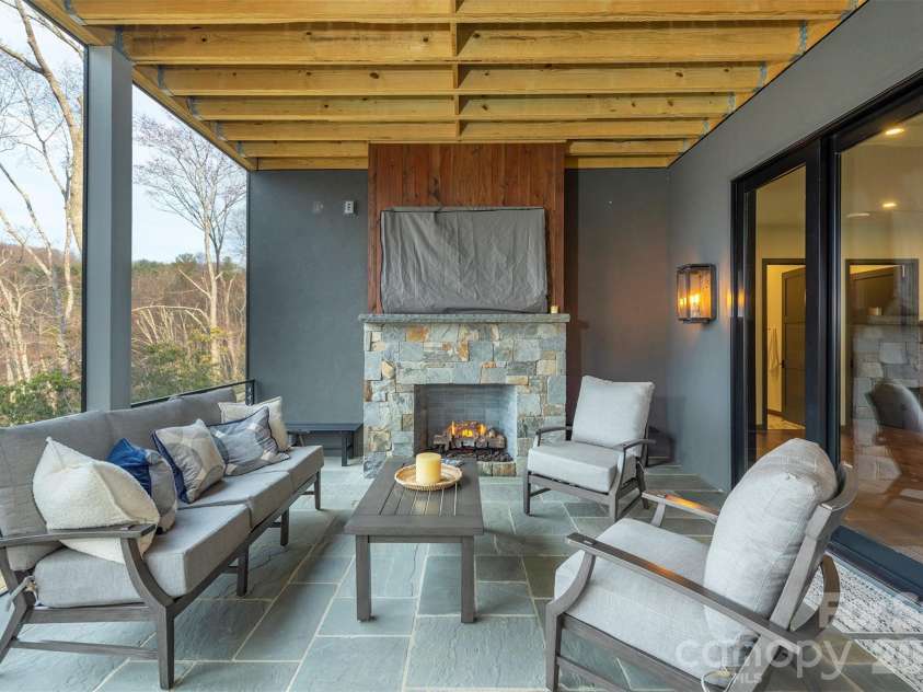 158 Riverbend Forest Drive, Asheville, NC 28805.  MLS# CAR4399646, YatesRealty ID 39092. Lower level deck with gas firepace