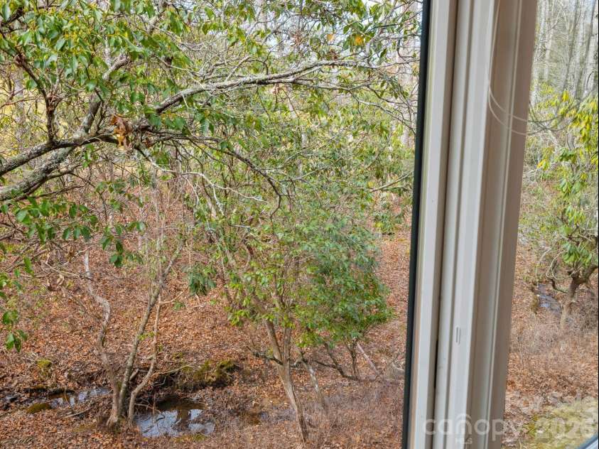 33 Ugedaliyvi Court, Brevard, NC 28712.  MLS# CAR4349656, YatesRealty ID 3911. Stream flow gently in the back yard