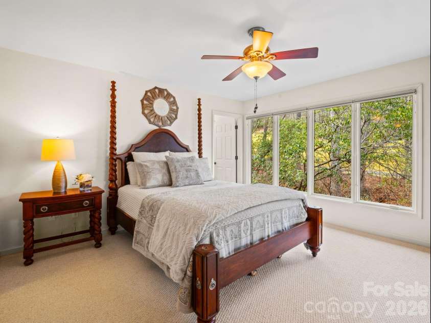 33 Ugedaliyvi Court, Brevard, NC 28712.  MLS# CAR4349656, YatesRealty ID 3911. The primary suite's huge windows face the private backyard 