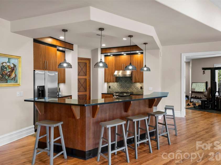 11717 Smart Lane, Charlotte, NC 28277.  MLS# CAR4403907, YatesRealty ID 39154. Full kitchen with gas, range, Fridge, microwave, dishwasher, sink w/disposal, ice maker, and access to the wine cellar.  Pub-Height Bar Counter.