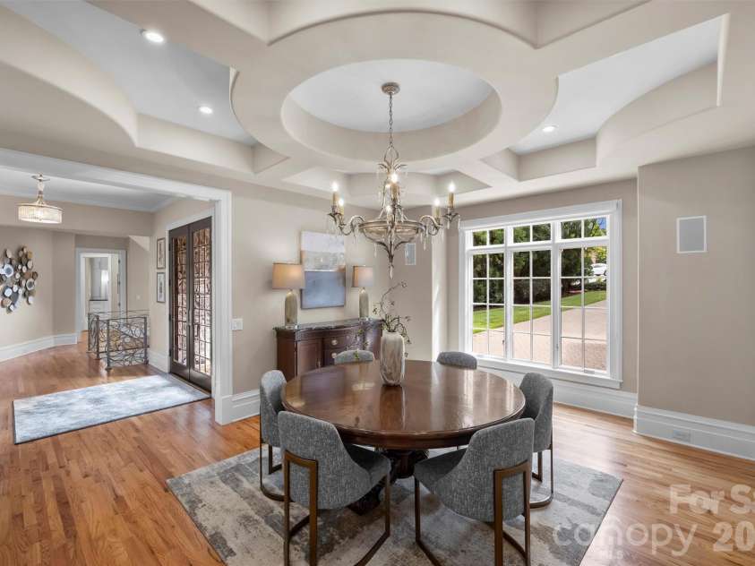 11717 Smart Lane, Charlotte, NC 28277.  MLS# CAR4403907, YatesRealty ID 39154. Spacious dining room featuring a stunning circular coffered ceiling and Fine Arts Chandelier. Full wet bar adjacent to dining room.