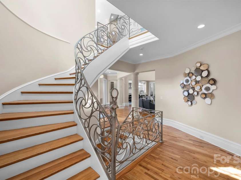 11717 Smart Lane, Charlotte, NC 28277.  MLS# CAR4403907, YatesRealty ID 39154. Sweeping freestanding metalwork staircase created by local artisan