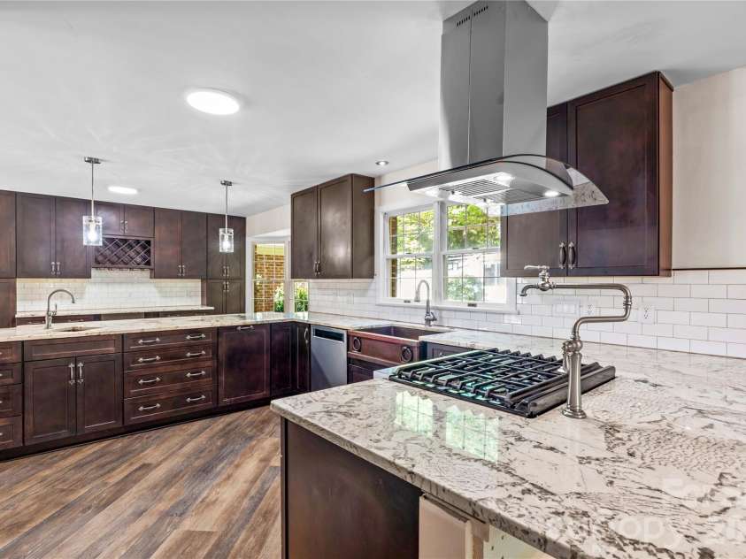 150 Kent Road, Salisbury, NC 28147.  MLS# CAR4399733, YatesRealty ID 39156. Custom cabinets and gorgeous quartzite work surfaces make cooking a delight. Counters for dining or serving on both sides of the gourmet kitchen.