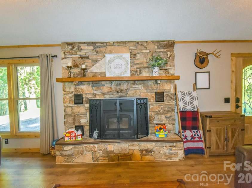 336 Hillside Road, Penrose, NC 28766.  MLS# CAR4405552, YatesRealty ID 39185. Fireplace with wood burning stove