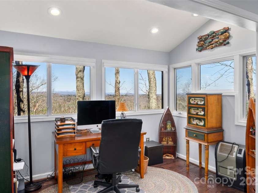 270 Ridge Drive, Saluda, NC 28773.  MLS# CAR4132159, YatesRealty ID 3919. Primary bedroom features spacious walk-in closet & separate sitting area w/ windows to picturesque views.