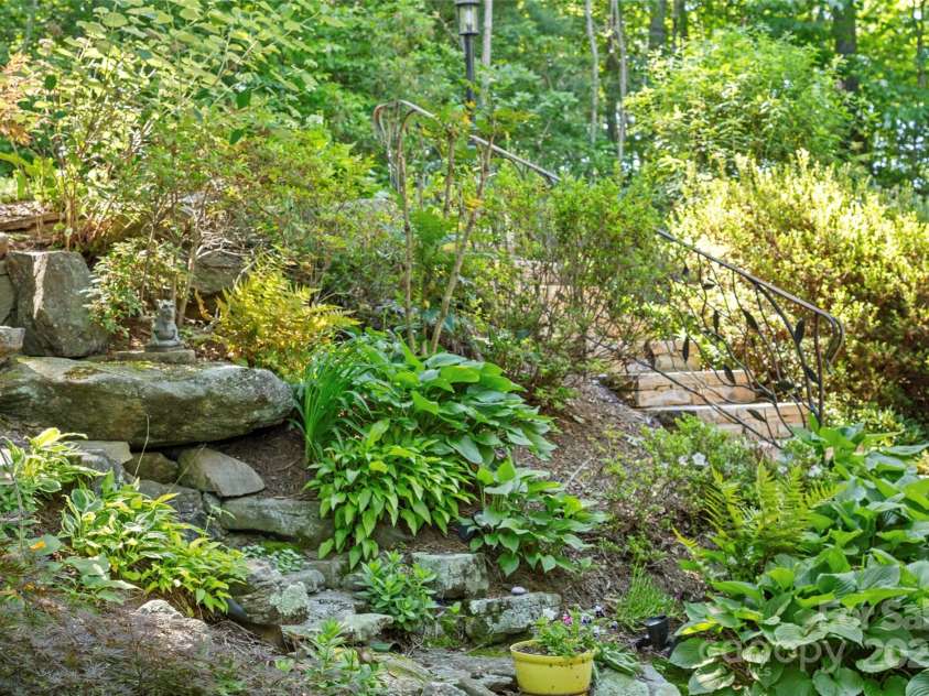 270 Ridge Drive, Saluda, NC 28773.  MLS# CAR4132159, YatesRealty ID 3919. Waterfall water-feature will delight and welcome you home. Custom wrought iron railing for made by a local artist.