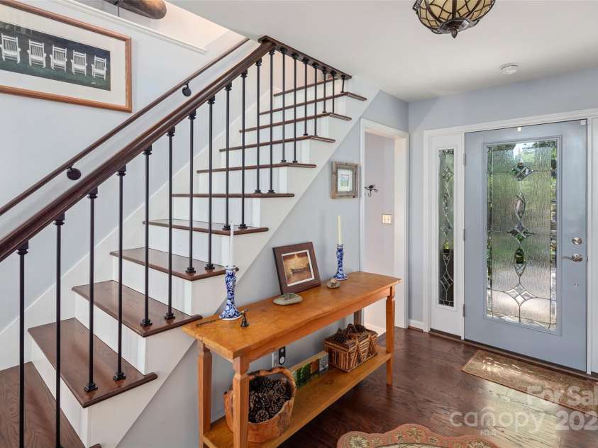 270 Ridge Drive, Saluda, NC 28773.  MLS# CAR4132159, YatesRealty ID 3919. Welcome! Foyer with stairs up to loft, and stairs down to lower level. Half bath (not pictured) is on the right.