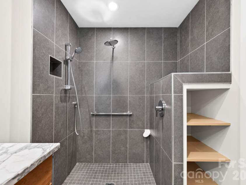 253 Edgewood Road, Asheville, NC 28804.  MLS# CAR4401448, YatesRealty ID 39237. Double headed tiled shower.