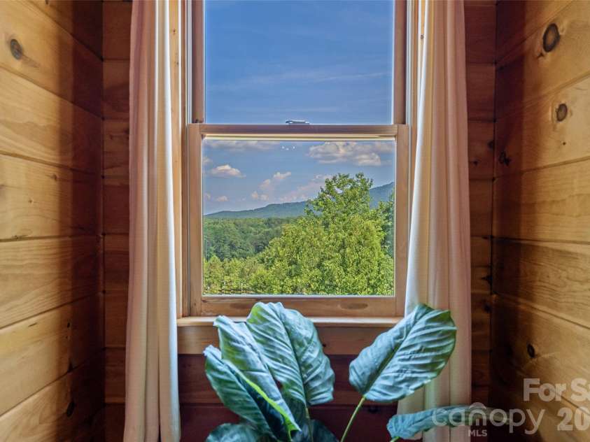 4551 Lake Adger Parkway, Mill Spring, NC 28756.  MLS# CAR4401928, YatesRealty ID 39249. Mountain view from primary suite dormer