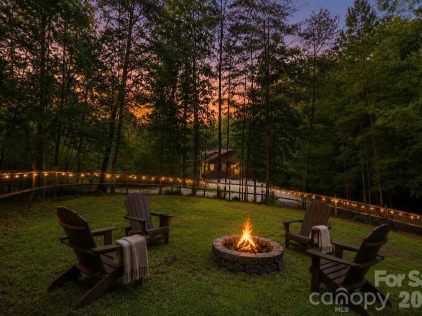 245 Mallard Road, Lake Lure, NC 28746.  MLS# CAR4405500, YatesRealty ID 39298. Virtual fire and chairs