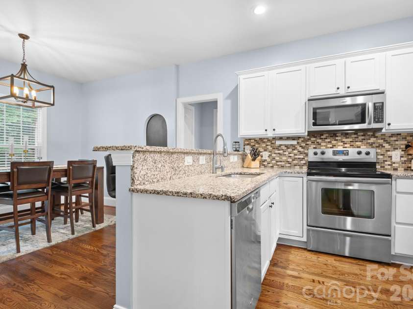 142 Valley Glen Drive, Troutman, NC 28166.  MLS# CAR4404466, YatesRealty ID 39305. Dining area overlooks backyard.