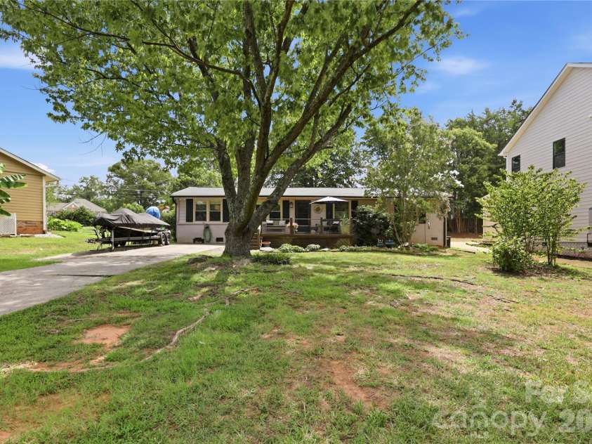 21013 Entrada Drive, Cornelius, NC 28031.  MLS# CAR4402041, YatesRealty ID 39320. A mature shade tree gives the front yard instant character.