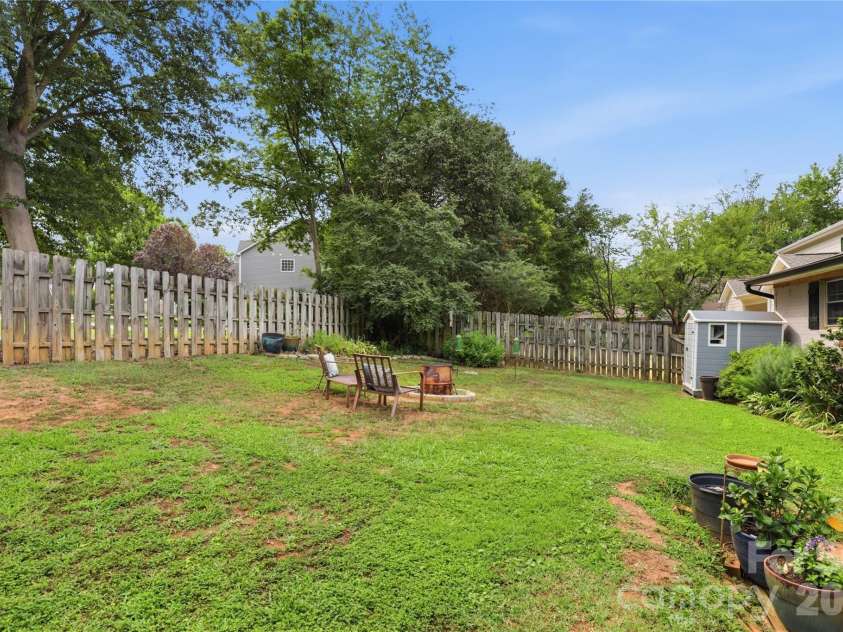 21013 Entrada Drive, Cornelius, NC 28031.  MLS# CAR4402041, YatesRealty ID 39320. A spacious backyard shaded by mature trees.