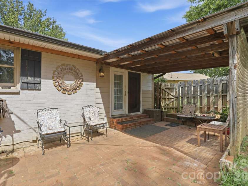 21013 Entrada Drive, Cornelius, NC 28031.  MLS# CAR4402041, YatesRealty ID 39320. Brick patio space overlooking the fenced backyard.