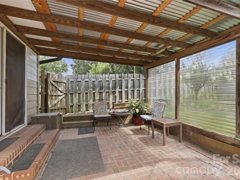 21013 Entrada Drive, Cornelius, NC 28031.  MLS# CAR4402041, YatesRealty ID 39320. Covered patio made for slow mornings and quiet evenings.