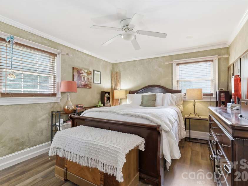 21013 Entrada Drive, Cornelius, NC 28031.  MLS# CAR4402041, YatesRealty ID 39320. Primary bedroom with warm natural light from two windows.