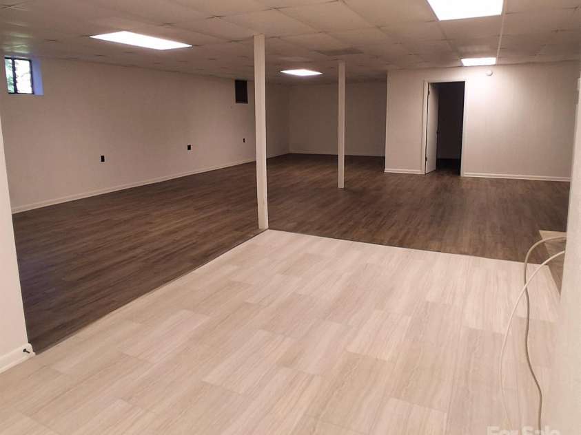 262 Rooster Cove, Brevard, NC 28712.  MLS# CAR4332799, YatesRealty ID 39326. Downstairs area includes fridge w/ icemaker, stove, microwave, bathroom and laundry amenities.