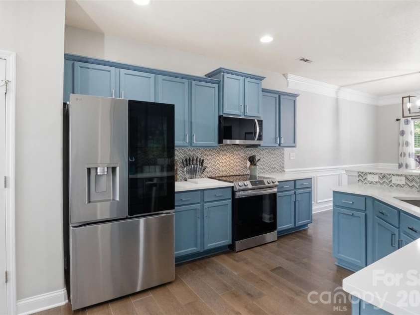 835 Estuary Court, Rock Hill, SC 29732.  MLS# CAR4401569, YatesRealty ID 39395. Kitchen with custom backsplash, custom painted cabinets and white quartz! Pantry has double doors for plenty of storage and easy access!