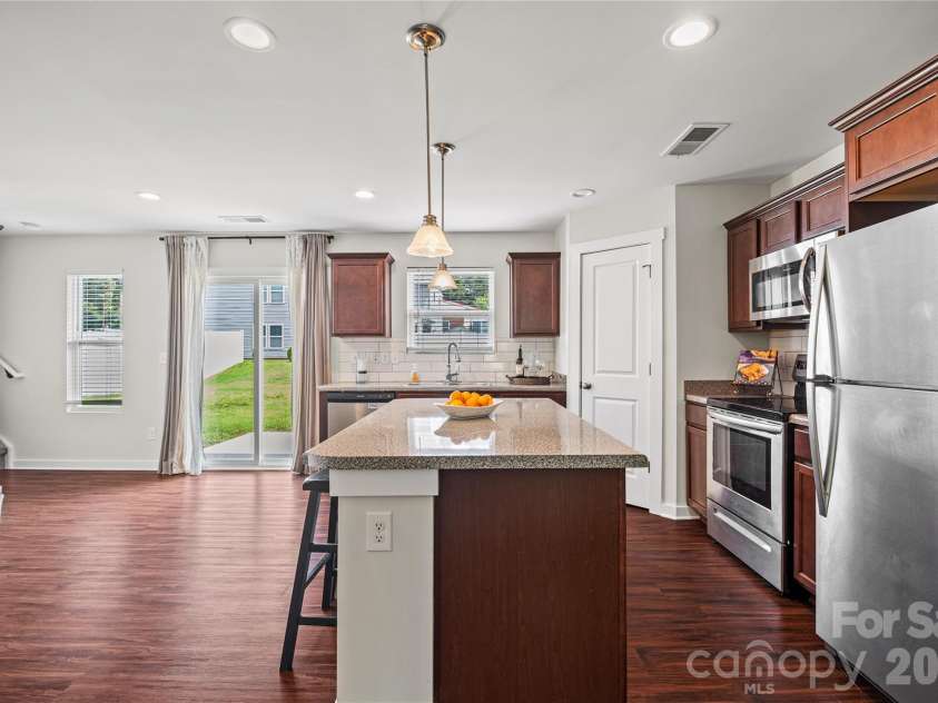 105 Beam Drive, Mooresville, NC 28115.  MLS# CAR4404578, YatesRealty ID 39454. Kitchen and breakfast area opens to the large, flat backyard.