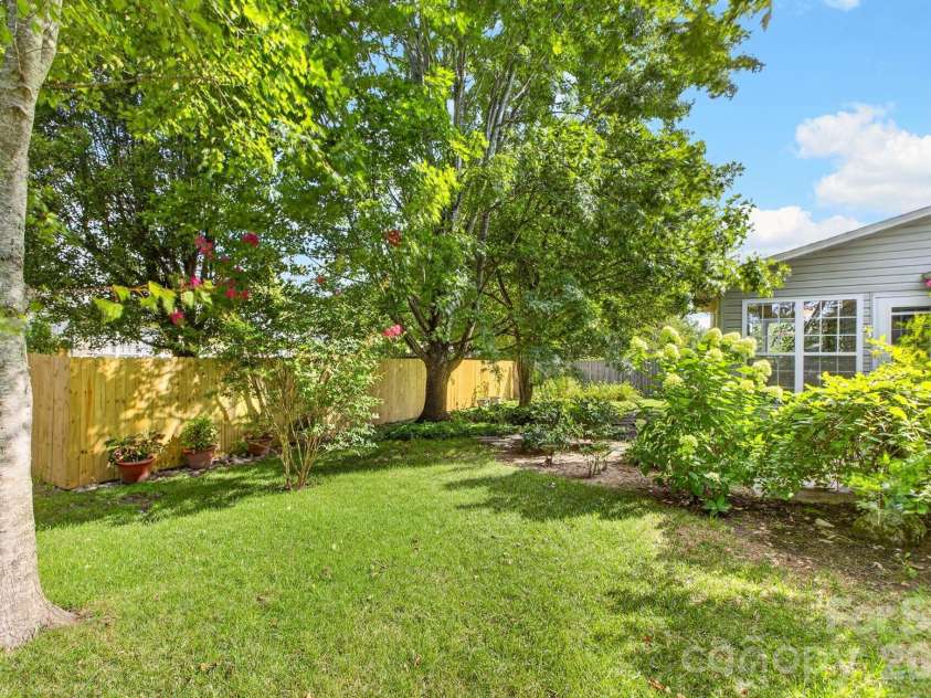 171 Running Briar Road, Fletcher, NC 28732.  MLS# CAR4403856, YatesRealty ID 39536. Backyard looking towards path and sunroom