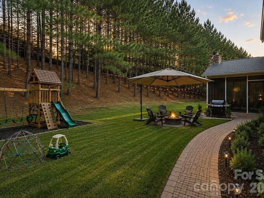 9052 Mossy Hill Lane, Fort Mill, SC 29707.  MLS# CAR4405984, YatesRealty ID 39559. AI rendering showing possibilites for backyard.