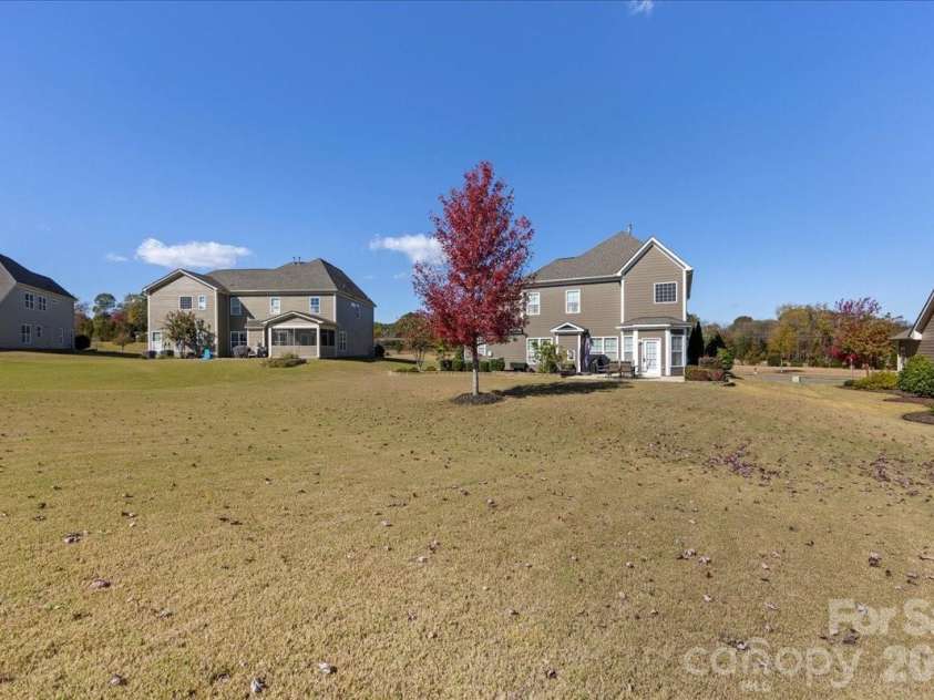 2511 Carnation Drive, Harrisburg, NC 28075.  MLS# CAR4345682, YatesRealty ID 3956. Backyard