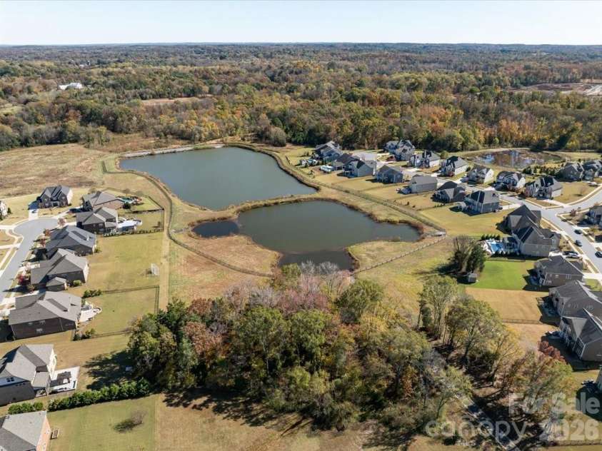 2511 Carnation Drive, Harrisburg, NC 28075.  MLS# CAR4345682, YatesRealty ID 3956. Community pond