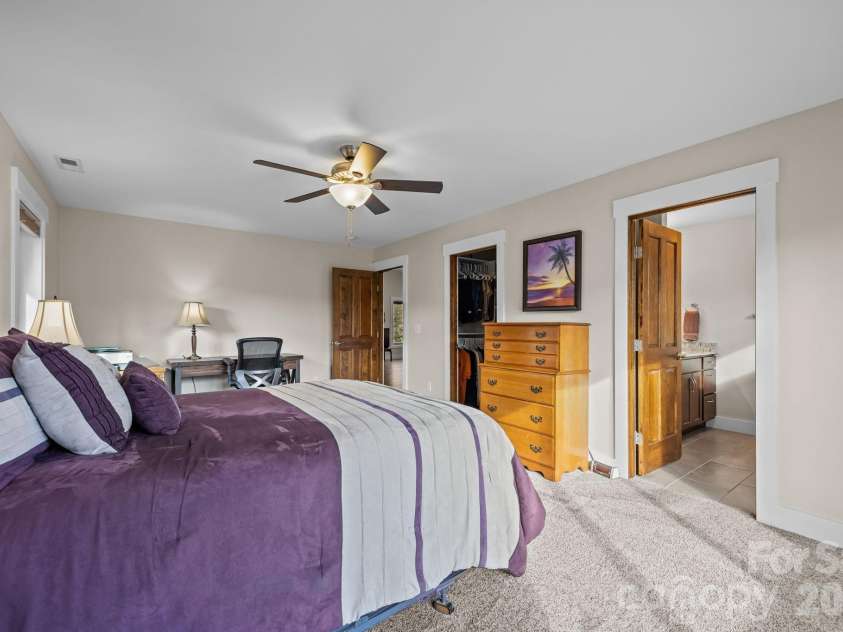 19 Dunsmore Avenue, Black Mountain, NC 28711.  MLS# CAR4337265, YatesRealty ID 3959. Soft, neutral carpet warms up this primary suite