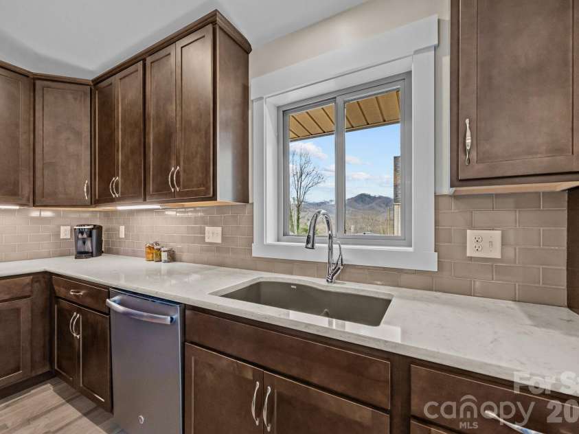 19 Dunsmore Avenue, Black Mountain, NC 28711.  MLS# CAR4337265, YatesRealty ID 3959. Undermount sink and a window over the kitchen sink.