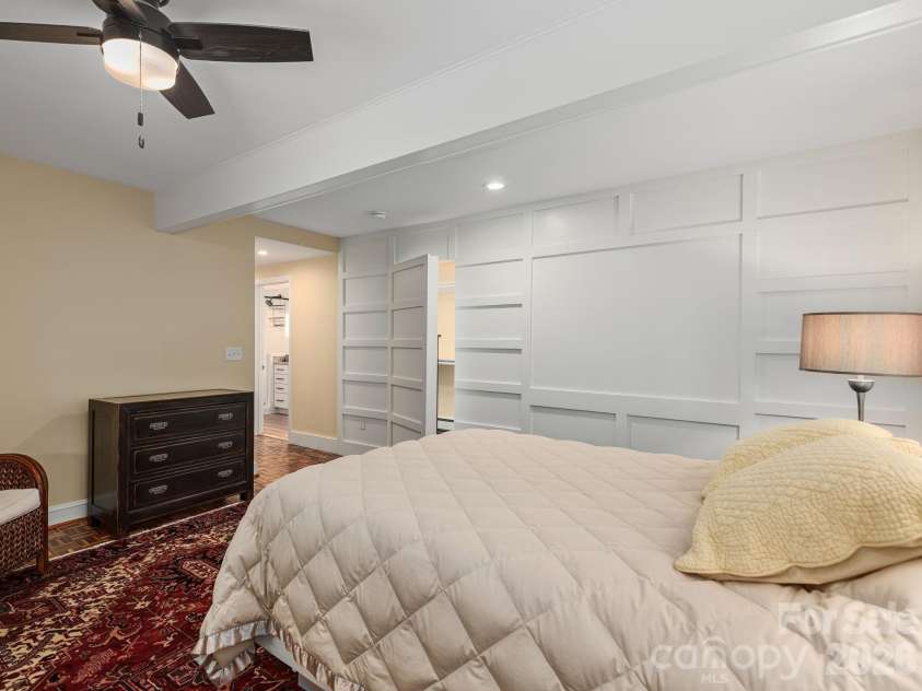 65 Cliff Drive, Laurel Park, NC 28739.  MLS# CAR4394753, YatesRealty ID 39607. A custom wall detail conceals the entrance to a spacious walk-in closet, adding a unique architectural touch while maximizing storage