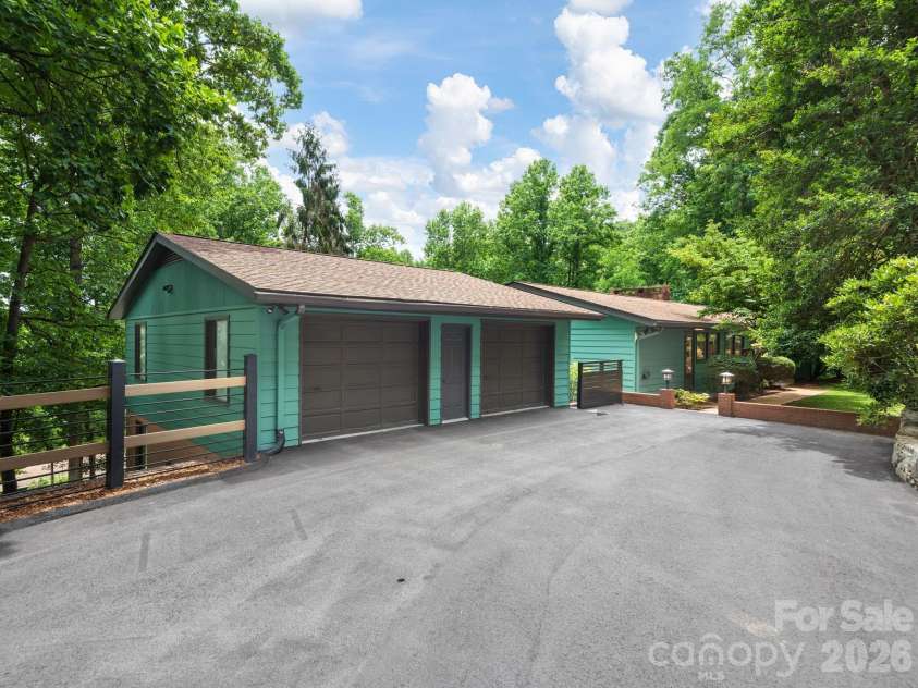 65 Cliff Drive, Laurel Park, NC 28739.  MLS# CAR4394753, YatesRealty ID 39607. A welcoming approach features a generous driveway, two-car garage