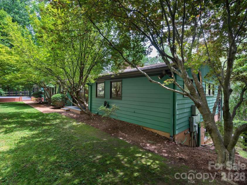 65 Cliff Drive, Laurel Park, NC 28739.  MLS# CAR4394753, YatesRealty ID 39607. Beautiful landscaping enhances the home’s clean architectural lines and timeless design