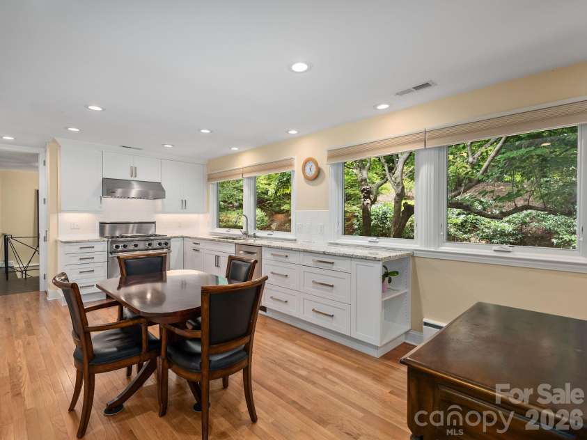 65 Cliff Drive, Laurel Park, NC 28739.  MLS# CAR4394753, YatesRealty ID 39607. Cook in style with Viking appliances, beautiful granite countertops, and a bright kitchen surrounded by views of the trees