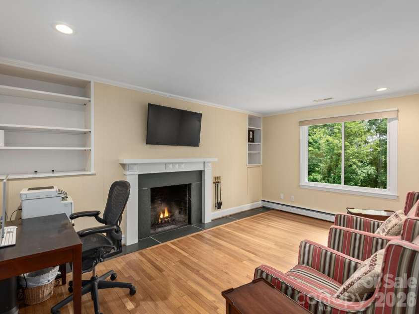 65 Cliff Drive, Laurel Park, NC 28739.  MLS# CAR4394753, YatesRealty ID 39607. Ideal as a home office or additional bedroom, this main level room,  built-in shelving, a closet, and convenient firewood storage