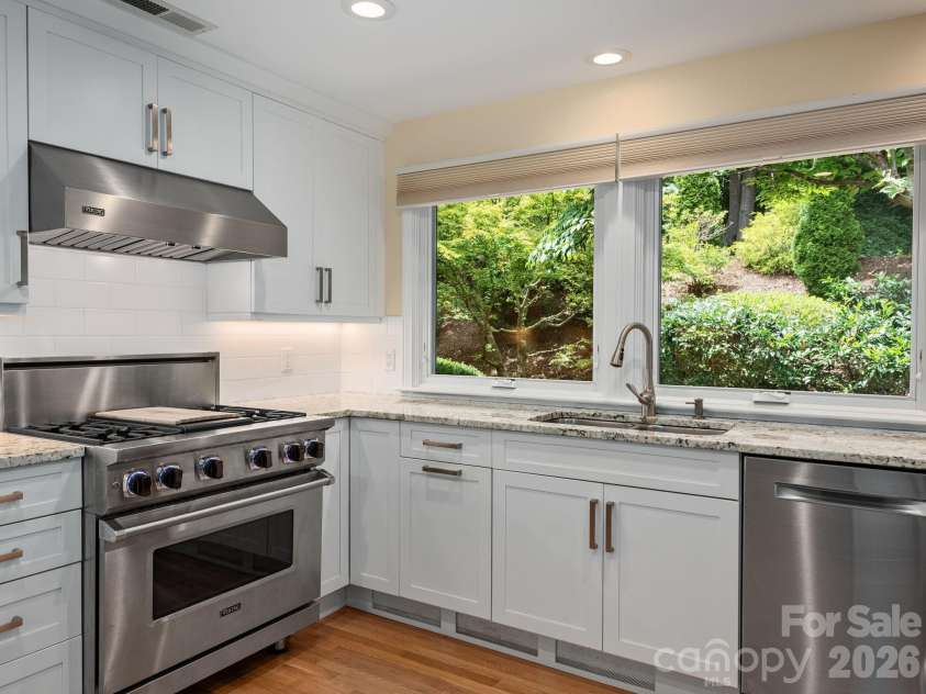 65 Cliff Drive, Laurel Park, NC 28739.  MLS# CAR4394753, YatesRealty ID 39607. Large windows fill the kitchen with natural light while framing lush views of the surrounding landscape