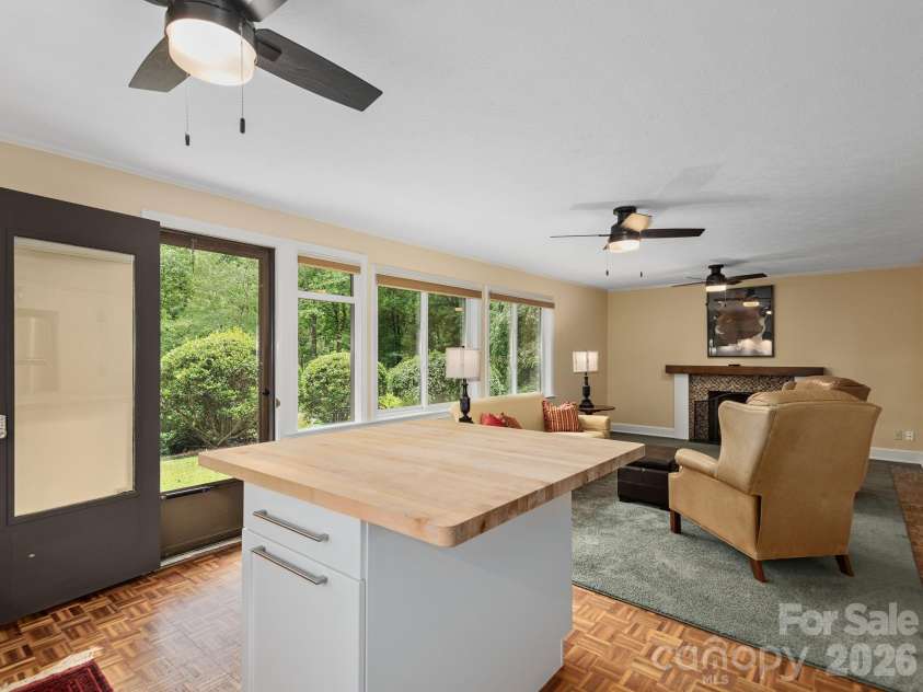 65 Cliff Drive, Laurel Park, NC 28739.  MLS# CAR4394753, YatesRealty ID 39607. Large windows flood the lower-level living space with natural light, while a private exterior entrance adds convenience and flexibility for guests or multi-generational living