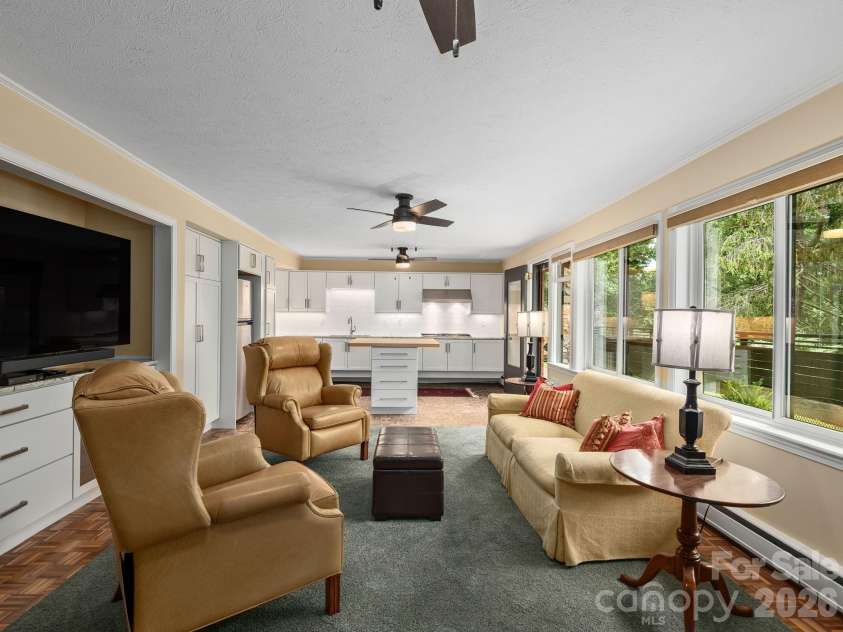 65 Cliff Drive, Laurel Park, NC 28739.  MLS# CAR4394753, YatesRealty ID 39607. Lower level offers a spacious second living area with a full kitchen, providing exceptional flexibility for guests, multi-generational living, or extended stays