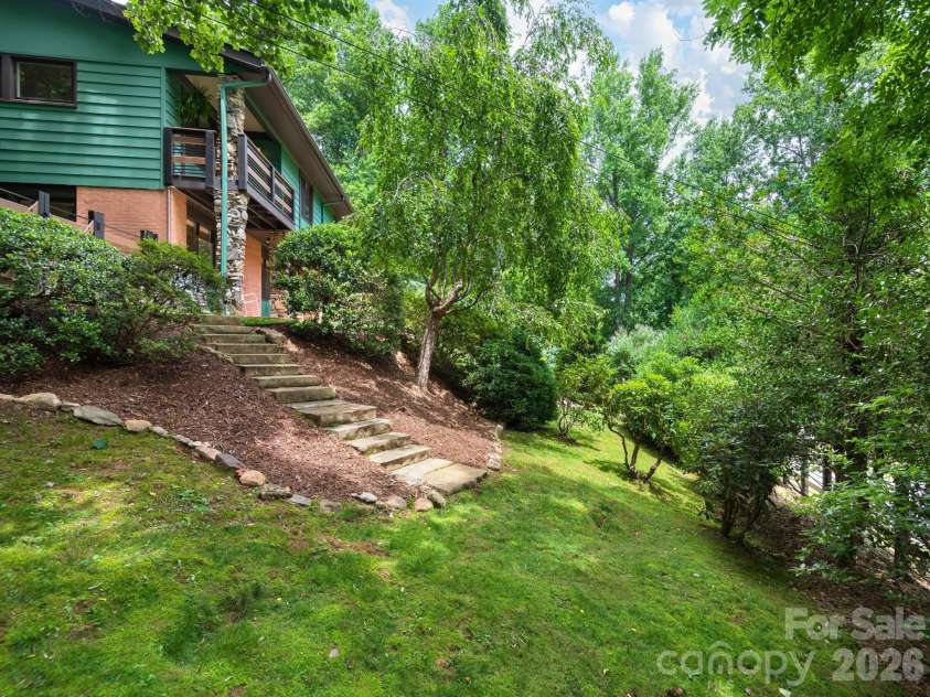 65 Cliff Drive, Laurel Park, NC 28739.  MLS# CAR4394753, YatesRealty ID 39607. Mature landscaping creates a private, park-like setting